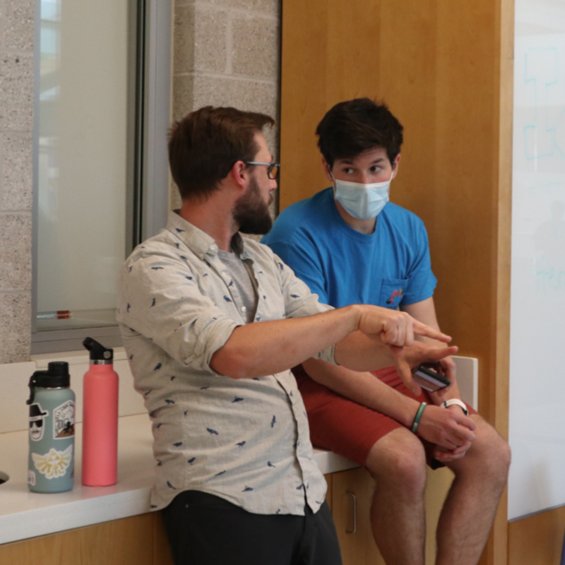 Tyler mentoring an undergraduate student at a campus poster session